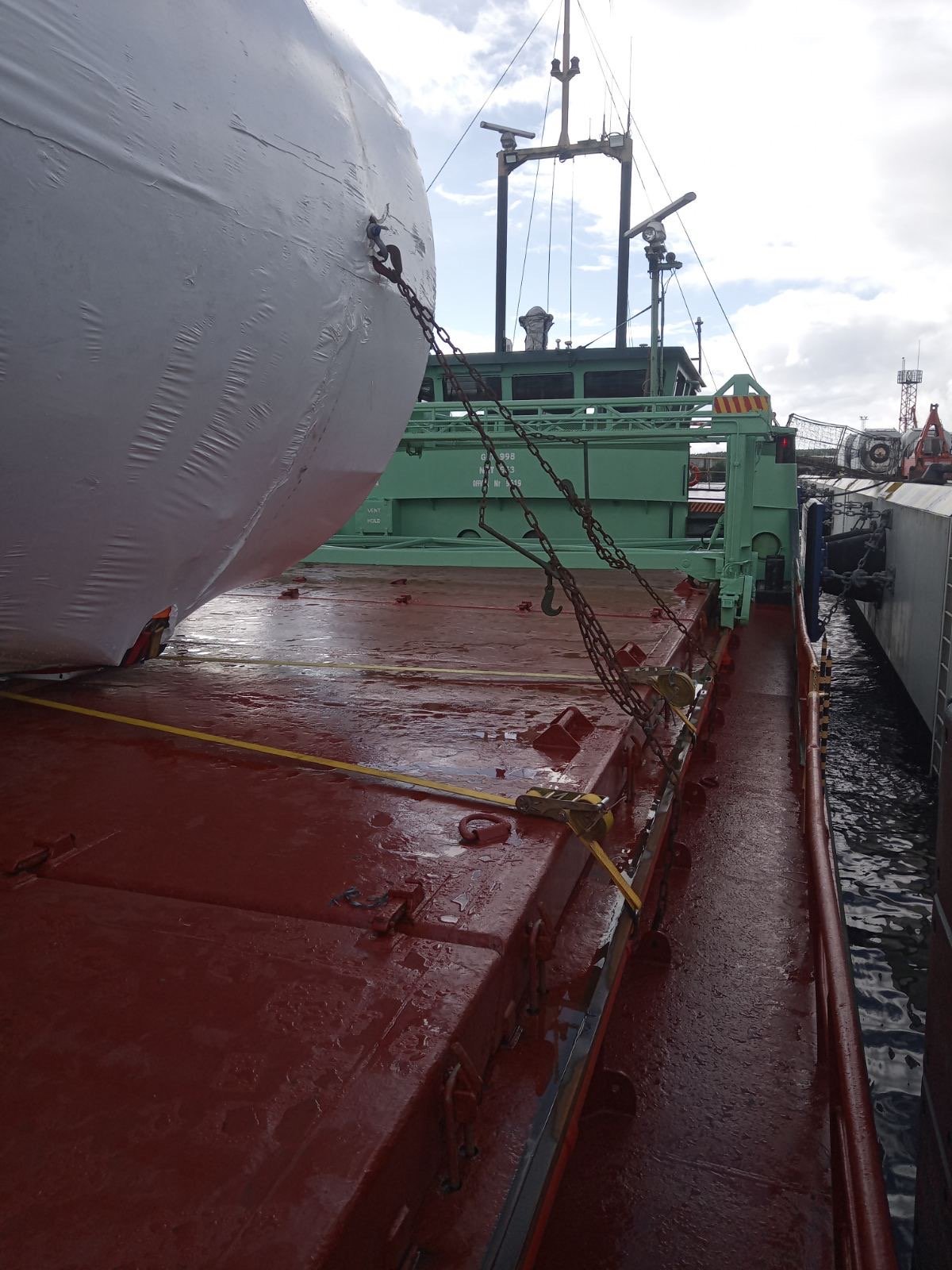 Chain and web-lashing connections securing a storage tank to existing deck lashing points