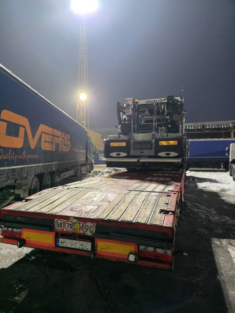 Oversized paver loaded on flatbed trailer in Poland