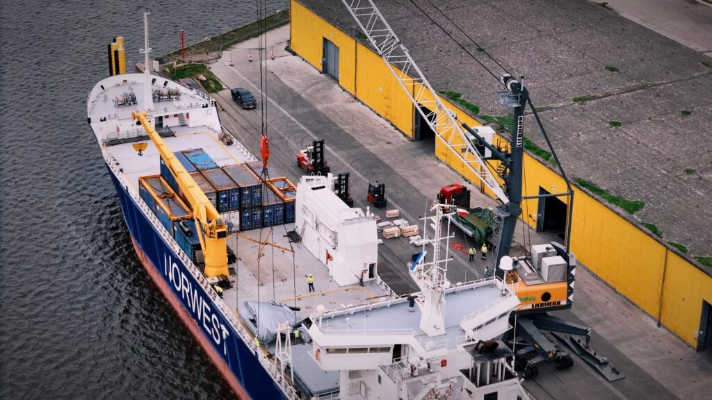 a breakbulk liner ship being loaded at port with oversized and heavy cargo