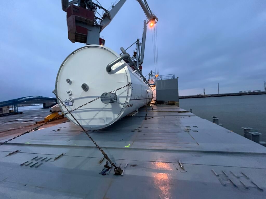 large tank secured with lashing chains on ship's deck