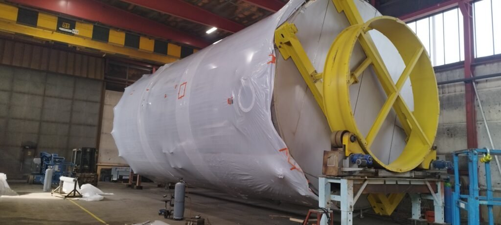 large steel tank being prepared for transportation